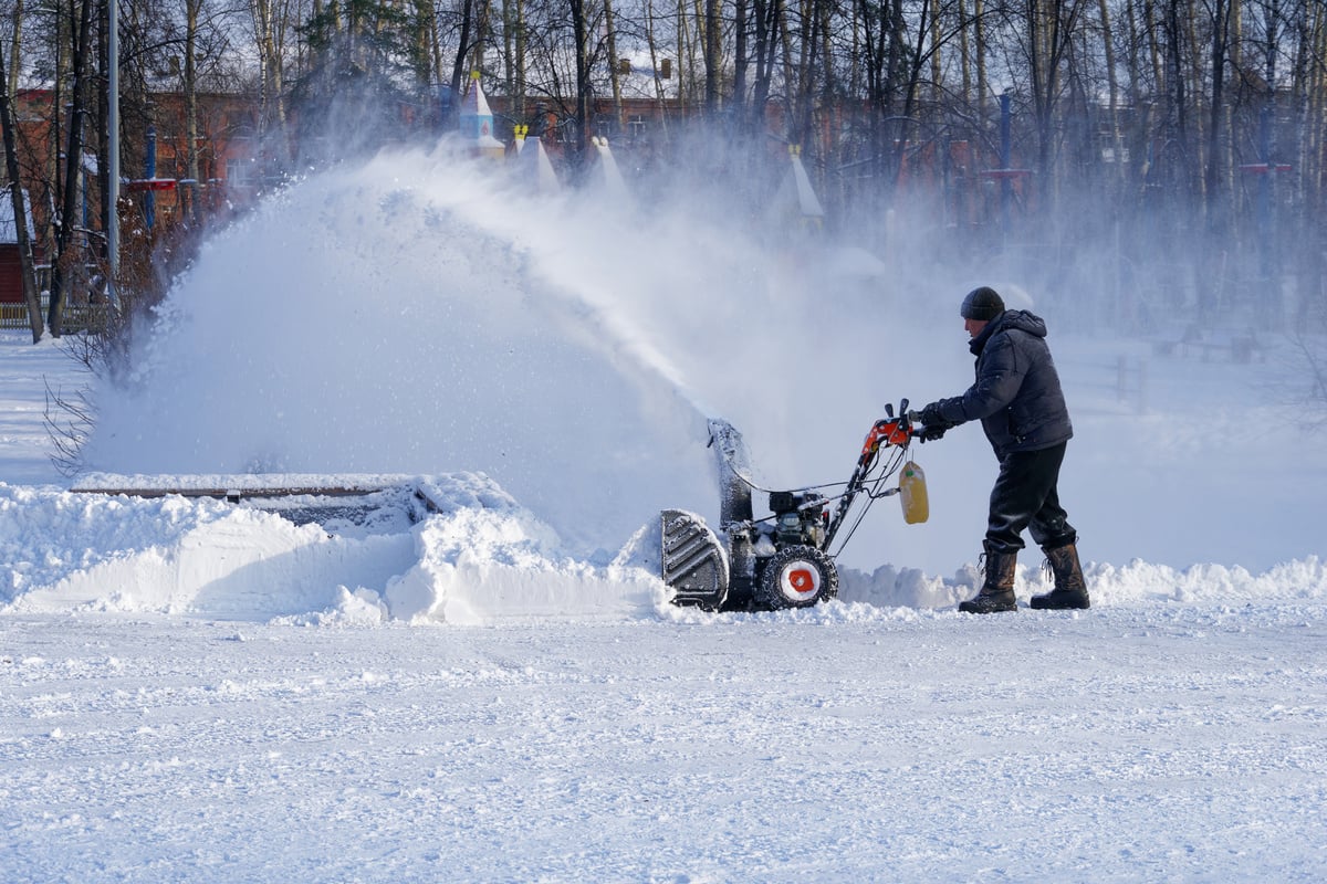 Man removing snow with snow blower